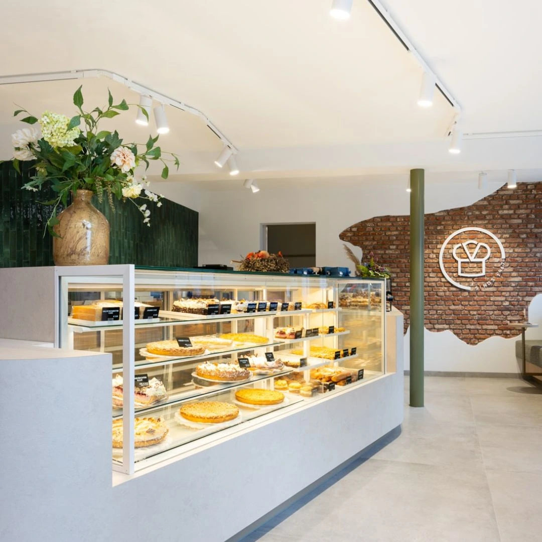winkelinrichting op maat met witte patisserie toonbank, glazen vitrine met taartproductpresentatie en modern bakkerij winkelinterieur